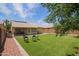 Well-maintained backyard featuring artificial grass and a covered patio, perfect for outdoor entertaining and relaxation at 3821 N 125Th Dr, Avondale, AZ 85392