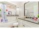Well-lit bathroom features a shower-tub combo with stylish tile and a granite vanity with a sink at 3821 N 125Th Dr, Avondale, AZ 85392