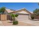Charming single-story home with desert landscaping, a two-car garage, and solar panels on the roof at 3821 N 125Th Dr, Avondale, AZ 85392