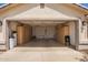 Spacious garage with ample cabinet storage and an open door, providing easy access at 3821 N 125Th Dr, Avondale, AZ 85392
