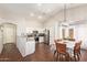 Bright kitchen with stainless steel appliances adjoins a dining area with seating for six at 3821 N 125Th Dr, Avondale, AZ 85392