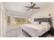 The primary bedroom boasts large windows, a ceiling fan and plush carpet at 3821 N 125Th Dr, Avondale, AZ 85392