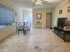 Open-concept living room with tile flooring, ceiling fan, and large windows at 4030 N 33Rd Pl, Phoenix, AZ 85018