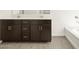 Bathroom with double sinks, modern vanity, and a bathtub at 4035 S 176Th Dr, Goodyear, AZ 85338