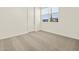 Bedroom with neutral carpet, light walls, window with blinds, and a white door at 4035 S 176Th Dr, Goodyear, AZ 85338