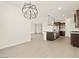 Spacious kitchen with a stainless steel sink, granite counters, and modern pendant lighting at 4035 S 176Th Dr, Goodyear, AZ 85338