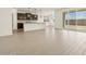 Bright, open living room with light wood-look flooring and sliding glass doors to the backyard at 4035 S 176Th Dr, Goodyear, AZ 85338