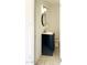 Cozy bathroom featuring a modern vanity, round mirror, and neutral tile flooring at 4810 N 69Th Dr Dr, Phoenix, AZ 85033