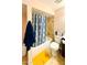 The cozy bathroom features a tiled shower-tub and colorful accents at 4810 N 69Th Dr Dr, Phoenix, AZ 85033
