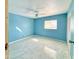 This bright, airy bedroom has tiled floors and a sunlit window at 4810 N 69Th Dr Dr, Phoenix, AZ 85033
