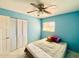 Comfortable bedroom features a ceiling fan, tiled floors, and closet at 4810 N 69Th Dr Dr, Phoenix, AZ 85033