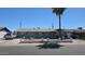 Charming single-story home with a palm tree in the front yard on a sunny day at 4810 N 69Th Dr Dr, Phoenix, AZ 85033