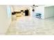 Open-concept living room with an adjacent kitchen area and bright natural light at 4810 N 69Th Dr Dr, Phoenix, AZ 85033