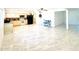 Bright living room featuring marble flooring and an open floor plan with a kitchen area at 4810 N 69Th Dr Dr, Phoenix, AZ 85033