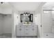 Modern bathroom featuring dual sinks, stylish mirror, and tiled walk-in shower at 4837 E Pershing Ave, Scottsdale, AZ 85254
