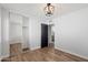Bedroom featuring wood floor, mirrored closet doors, and modern lighting at 4837 E Pershing Ave, Scottsdale, AZ 85254