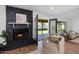 Cozy living room with fireplace, plush chair, and French doors to the backyard at 4837 E Pershing Ave, Scottsdale, AZ 85254
