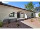 Unique front entry with a decorative archway, well-kept landscaping, and welcoming walkway at 4837 E Pershing Ave, Scottsdale, AZ 85254