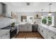 Bright kitchen featuring white cabinets, subway tile backsplash, and stainless steel appliances at 4837 E Pershing Ave, Scottsdale, AZ 85254
