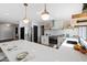 Modern kitchen with stainless steel appliances, white cabinets and large marble island at 4837 E Pershing Ave, Scottsdale, AZ 85254