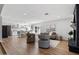 Open-concept living room with kitchen, fireplace, wood floors, and modern furnishings at 4837 E Pershing Ave, Scottsdale, AZ 85254
