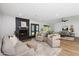 Spacious living room with fireplace, modern furnishings, and wood flooring at 4837 E Pershing Ave, Scottsdale, AZ 85254