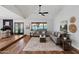 Vaulted living room featuring a ceiling fan, fireplace and plush seating arrangement at 4837 E Pershing Ave, Scottsdale, AZ 85254