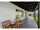 Covered back patio featuring a brick privacy wall and wooden chairs with a view of the yard at 4837 E Pershing Ave, Scottsdale, AZ 85254