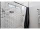 Stylish tiled shower with a sleek shower head and black hardware at 4837 E Pershing Ave, Scottsdale, AZ 85254