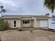 Charming single-story home featuring a desert landscape, attached garage, and a covered front patio area at 4910 E Charter Oak Rd, Scottsdale, AZ 85254
