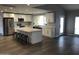 Bright kitchen features white cabinets, stainless steel appliances, large island with seating, and hardwood floors at 4910 E Charter Oak Rd, Scottsdale, AZ 85254