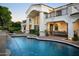 Resort-style backyard showcasing a large pool, covered patio with dining area, and lush landscaping at 5610 E Sanna St, Paradise Valley, AZ 85253
