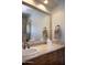 Bathroom featuring a large mirror and a tile-framed vanity with a sink and a shower at 5610 E Sanna St, Paradise Valley, AZ 85253