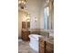 Bright bathroom with a soaking tub, double sinks with wood cabinets, tile accents, and plantation shutters at 5610 E Sanna St, Paradise Valley, AZ 85253