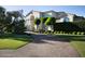 Long, winding driveway leading to a distinguished home, surrounded by manicured landscaping and mature trees at 5610 E Sanna St, Paradise Valley, AZ 85253