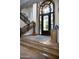 Elegant foyer showcasing a stunning wrought iron front door, travertine floors and a staircase at 5610 E Sanna St, Paradise Valley, AZ 85253