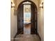 Elegant hallway showcases an arched doorway leading to a relaxing sitting area with a chaise lounge at 5610 E Sanna St, Paradise Valley, AZ 85253