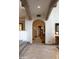 Arched hallway with detailed millwork, travertine floors, and recessed lighting at 5610 E Sanna St, Paradise Valley, AZ 85253