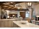 Open kitchen with a large island, coffered ceilings, and stainless steel appliances at 5610 E Sanna St, Paradise Valley, AZ 85253