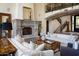 Inviting living room with a grand stone fireplace, comfortable sofas, and stylish décor at 5610 E Sanna St, Paradise Valley, AZ 85253