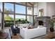Bright living room with a stone fireplace, large windows showcasing the views, and comfortable seating at 5610 E Sanna St, Paradise Valley, AZ 85253