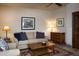 Inviting living room with a plush sofa, wooden coffee table, and warm lighting, perfect for relaxing and entertaining at 5610 E Sanna St, Paradise Valley, AZ 85253