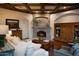 Comfortable living room with stone fireplace, hardwood floors, and elegant furnishings at 5610 E Sanna St, Paradise Valley, AZ 85253