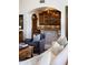 Living room featuring built in bar area, stone accents, and travertine floors at 5610 E Sanna St, Paradise Valley, AZ 85253