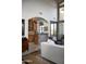 Bright living room featuring a wet bar with granite counters and light wood cabinets at 5610 E Sanna St, Paradise Valley, AZ 85253