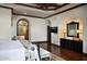 Tranquil main bedroom featuring coffered ceilings, wood floors, sitting area, and an ensuite bathroom entrance at 5610 E Sanna St, Paradise Valley, AZ 85253