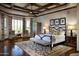 Spacious main bedroom boasts a coffered ceiling, hardwood floors, sitting area, and ample natural light at 5610 E Sanna St, Paradise Valley, AZ 85253