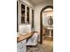 Bright office space featuring custom cabinetry, built-in shelves, a hardwood desk, and adjacent bathroom at 5610 E Sanna St, Paradise Valley, AZ 85253
