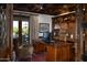 Executive office with custom wood built-ins, coffered ceilings, and an adjacent patio space at 5610 E Sanna St, Paradise Valley, AZ 85253