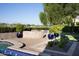 Inviting backyard patio with a stone fireplace, comfortable seating, a putting green, and manicured landscaping at 5610 E Sanna St, Paradise Valley, AZ 85253